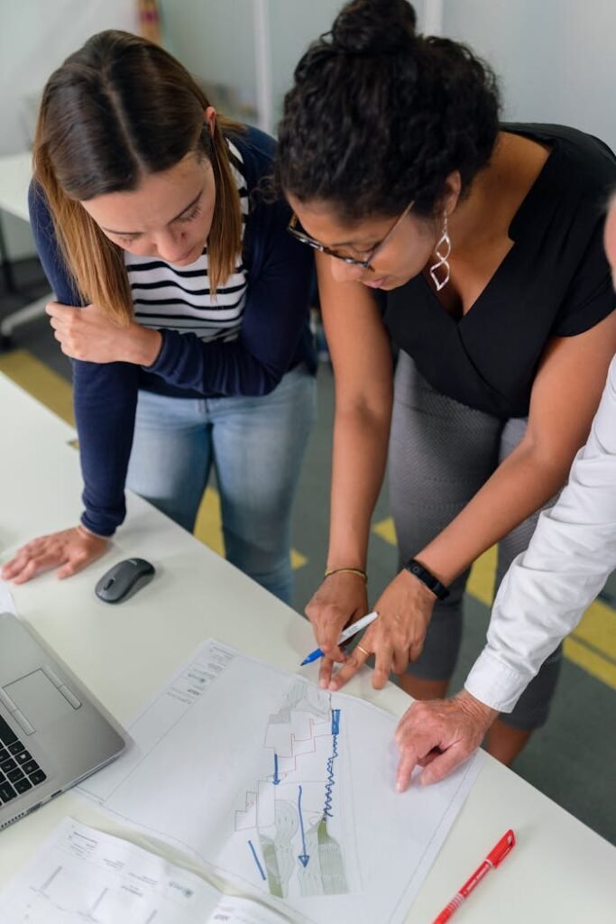 Photo Of Women Analyzing Work